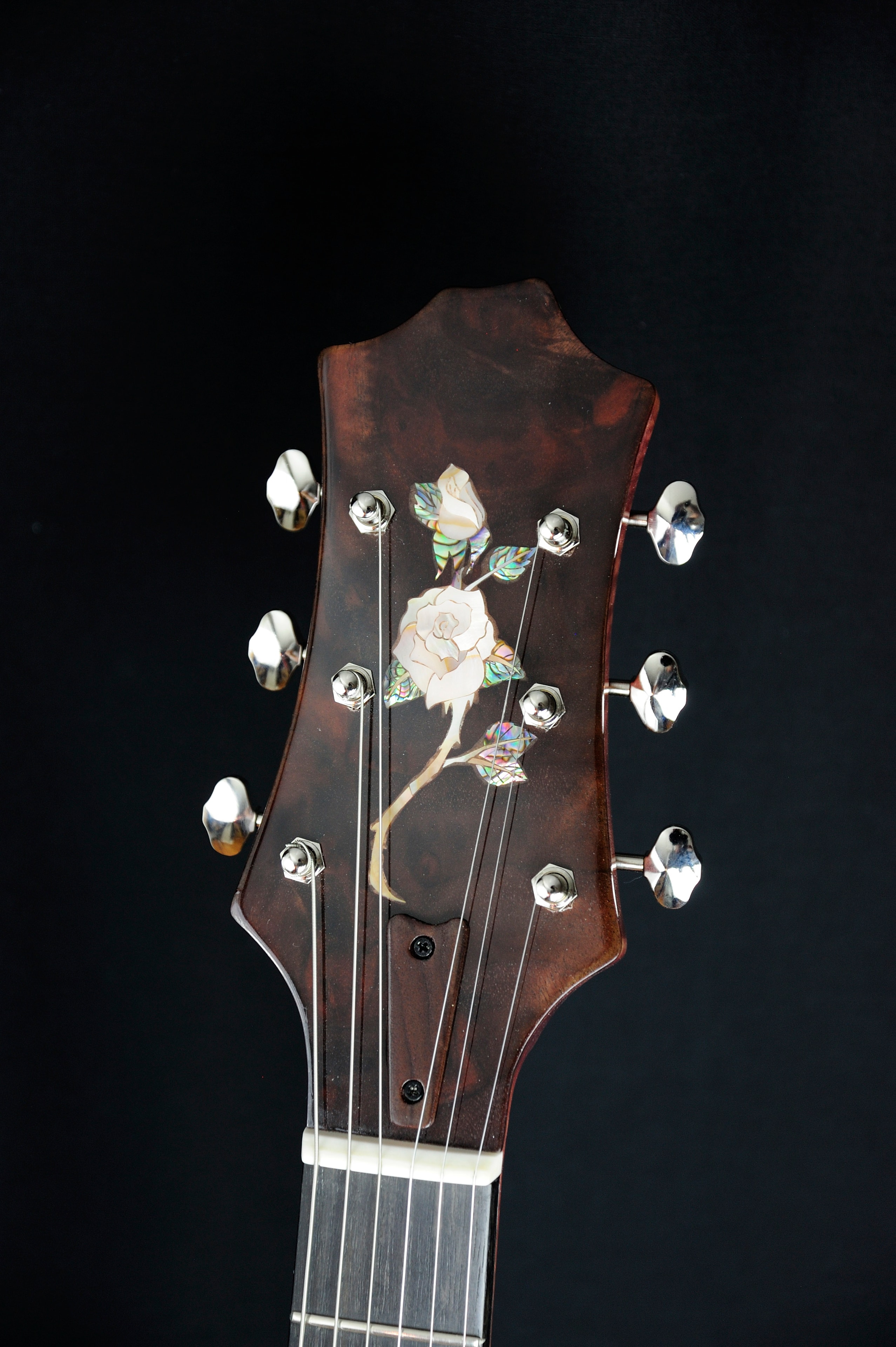 MRK02A — headstock front with mother-of-pearl rose inlay