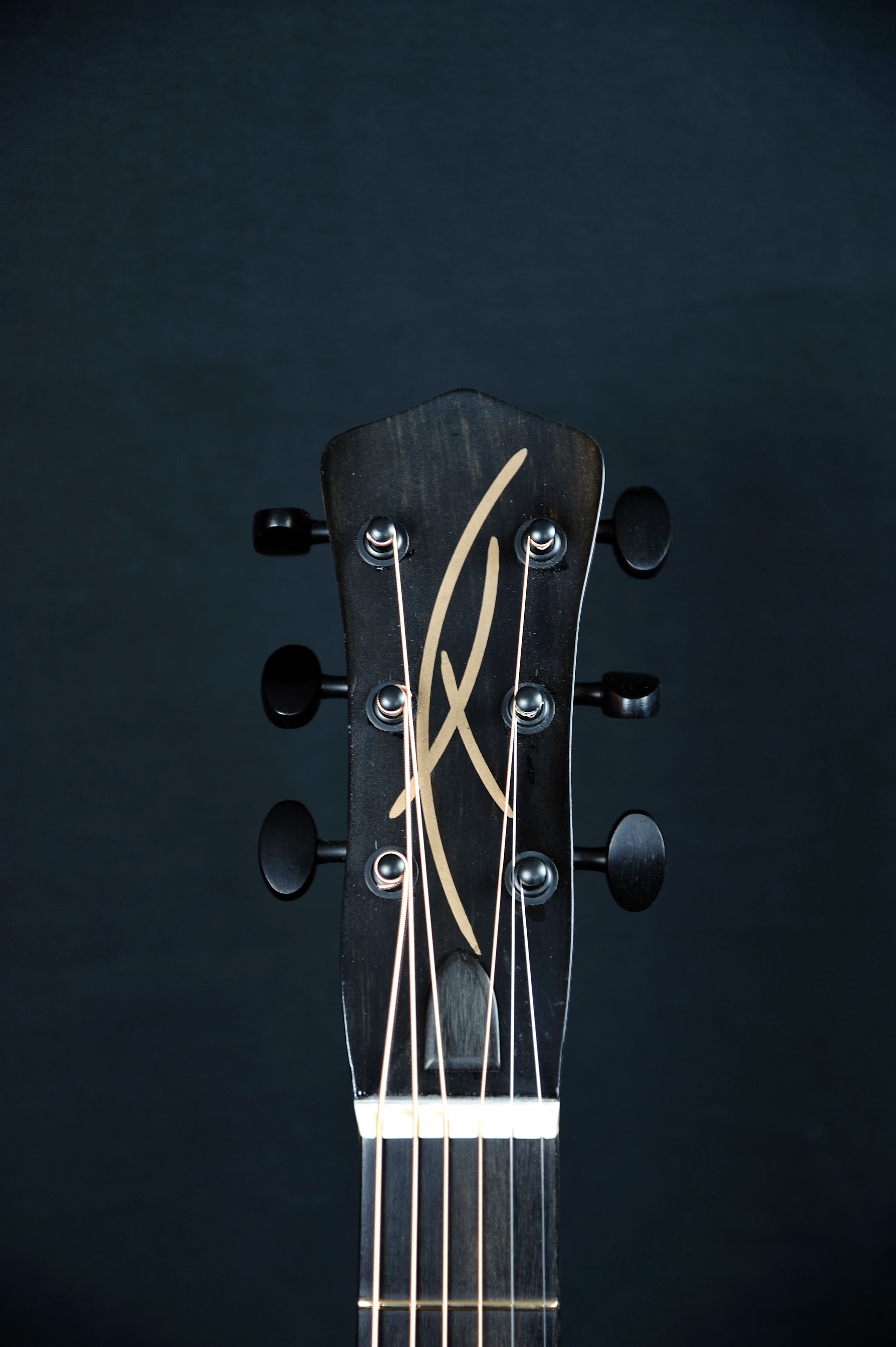 MRK01B-0717L — headstock front showing ebony head plate with copper inlay